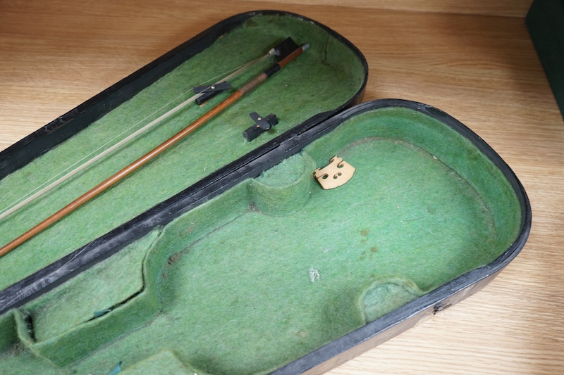 A 19th century cased violin and bow, body of violin 35.5cm long. Condition - needs restringing